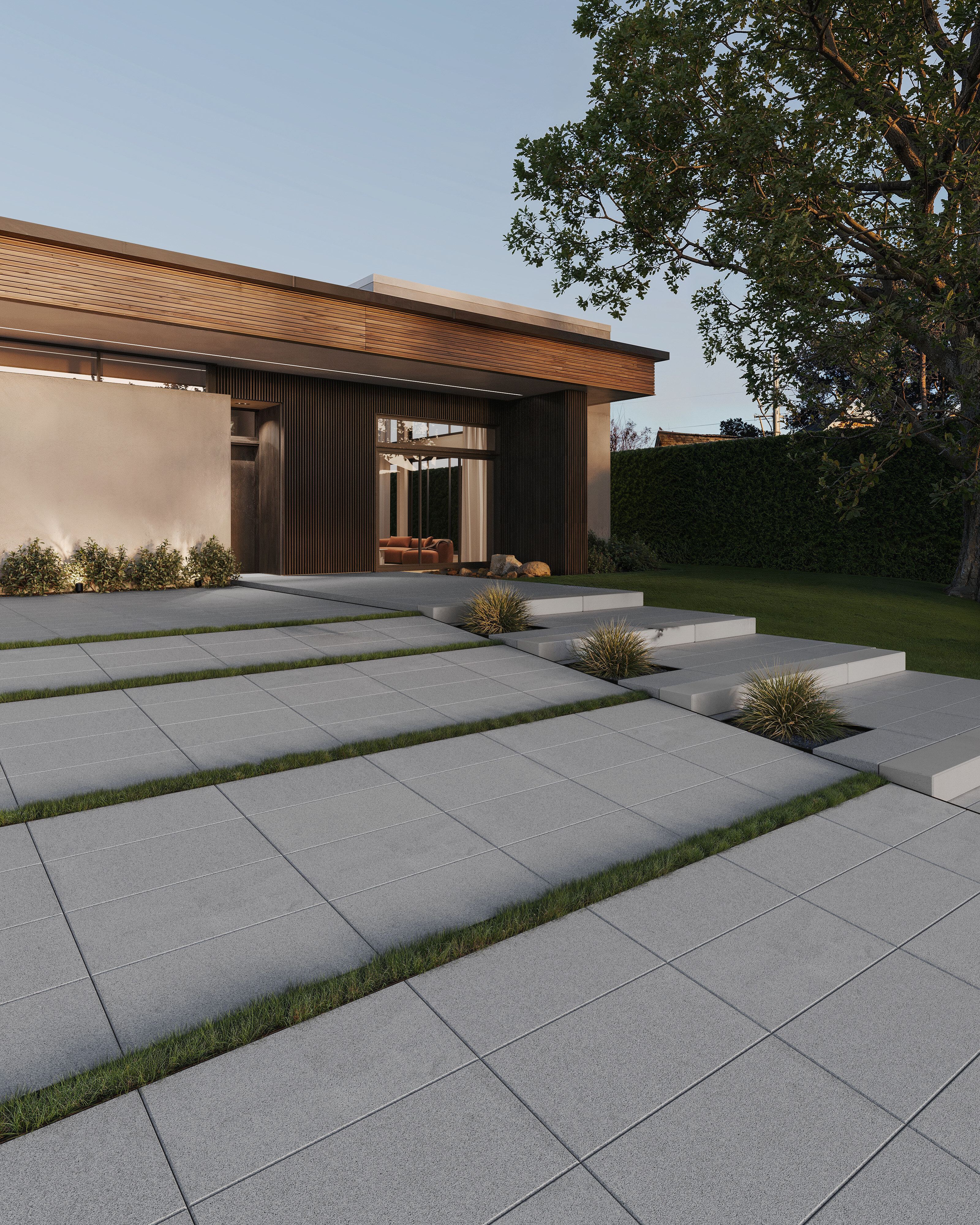 Una entrada de auto moderna que presenta el adoquín Sleek de Techo-Bloc en el color Silver Granite. 